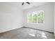 Bright bedroom with a large window providing natural light and neutral colored carpet at 812 East St, Smithfield, NC 27577
