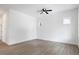 Minimalist bedroom with neutral walls, wood flooring, a ceiling fan, and abundant natural light from multiple windows at 812 East St, Smithfield, NC 27577