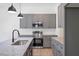 Well-equipped kitchen featuring gray cabinets, stainless steel appliances, and granite countertops at 812 East St, Smithfield, NC 27577