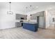 Open-concept kitchen with gray cabinets, stainless steel appliances, and a blue island with pendant lighting at 812 East St, Smithfield, NC 27577
