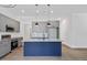 Modern kitchen featuring gray cabinetry, granite countertops, stainless steel appliances, and a striking blue island at 812 East St, Smithfield, NC 27577