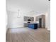 Spacious open-concept kitchen with gray cabinets, granite countertops, stainless appliances, and a blue island at 812 East St, Smithfield, NC 27577