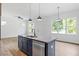 Open kitchen featuring a center island with granite countertops, pendant lights and stainless steel appliances at 812 East St, Smithfield, NC 27577