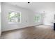 Open-concept living room with wood floors, white walls, and abundant natural light from large windows at 812 East St, Smithfield, NC 27577