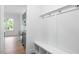 Mudroom area with built in bench and hooks, next to a kitchen with gray cabinets at 812 East St, Smithfield, NC 27577