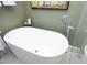 A close up of a modern, white soaking tub in a bathroom with neutral decor at 817 Old Mill Rd, Chapel Hill, NC 27514