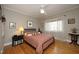 Comfortable bedroom with ceiling fan, hardwood floors and lots of natural light at 817 Old Mill Rd, Chapel Hill, NC 27514