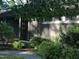Exterior of home with grey brick and beautiful landscaping including decorative shrubs and gravel walkway at 817 Old Mill Rd, Chapel Hill, NC 27514