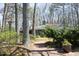 Inviting brick pathway leading to a beautifully landscaped home surrounded by mature trees at 817 Old Mill Rd, Chapel Hill, NC 27514