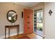 Light-filled foyer featuring a front door, wooden floors, a mirror, and an accent table at 817 Old Mill Rd, Chapel Hill, NC 27514