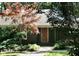 Charming single story home with a red front door and lush landscaping at 817 Old Mill Rd, Chapel Hill, NC 27514