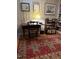 Cozy home office features a wooden desk, chair, and shelving with books over a classic red rug at 817 Old Mill Rd, Chapel Hill, NC 27514