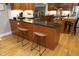 Modern kitchen with granite counters, wood cabinets, and seating at the island at 817 Old Mill Rd, Chapel Hill, NC 27514