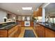 Bright kitchen with wood cabinets, hardwood floors, granite countertops, and a skylight at 817 Old Mill Rd, Chapel Hill, NC 27514