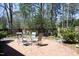 Outdoor patio with brick pavers, table and chairs, and lush greenery at 817 Old Mill Rd, Chapel Hill, NC 27514