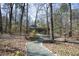Landscaped yard with trees and path leading to the house at 817 Old Mill Rd, Chapel Hill, NC 27514