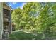 Landscaped backyard featuring a black fence, mature trees, and outdoor living space for relaxation at 85 Christenbury Ln, Clayton, NC 27527