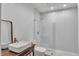 Modern bathroom featuring herringbone tiled shower, vessel sink, stylish fixtures, and glass shower door at 85 Christenbury Ln, Clayton, NC 27527