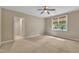 Large bedroom with plush carpeting and a sunny window with views of the surrounding greenery at 85 Christenbury Ln, Clayton, NC 27527