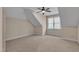 Neutral bedroom offers angled ceilings, a ceiling fan, a large window, and plush carpeting throughout at 85 Christenbury Ln, Clayton, NC 27527