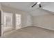 Neutral bedroom leading to an en-suite bathroom, offers angled ceilings, a ceiling fan, and plush carpeting throughout at 85 Christenbury Ln, Clayton, NC 27527