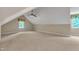 Bonus room offers neutral paint, plush carpeting, a ceiling fan, and dual windows for natural light at 85 Christenbury Ln, Clayton, NC 27527