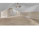 Bonus room offers neutral paint, plush carpeting, a ceiling fan, and ample space for activities at 85 Christenbury Ln, Clayton, NC 27527