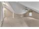 Large bonus room featuring neutral carpeting, a ceiling fan, and natural light from the window at 85 Christenbury Ln, Clayton, NC 27527