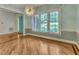 Dining room with hardwood floors, large windows, and designer light fixture at 85 Christenbury Ln, Clayton, NC 27527