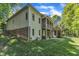 Exterior of home showcasing a multi-level deck, well-kept lawn, and tasteful brick accents at 85 Christenbury Ln, Clayton, NC 27527