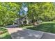 Two-story home with a long driveway, lush greenery, and well-manicured lawn at 85 Christenbury Ln, Clayton, NC 27527