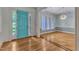 Inviting foyer features a bright blue front door, hardwood floors, and views into the dining room at 85 Christenbury Ln, Clayton, NC 27527