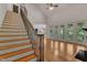 Open living room featuring a staircase with iron railings and views to the backyard at 85 Christenbury Ln, Clayton, NC 27527