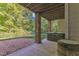Backyard patio with brick columns, covered hot tub, gravel area, and view of trees at 85 Christenbury Ln, Clayton, NC 27527