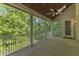 Spacious screened-in porch boasts a wood ceiling, ceiling fan, and a scenic view of the lush surrounding trees at 85 Christenbury Ln, Clayton, NC 27527