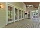 Relaxing sunroom featuring a wood ceiling, ceiling fan, and an abundance of light from the large glass doors and windows at 85 Christenbury Ln, Clayton, NC 27527