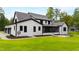 Spacious backyard with a screened-in porch, lush green lawn, and tasteful landscaping at 92 Bluffside Ct, Pittsboro, NC 27312