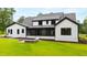 Expansive backyard with a screened porch, lush lawn, and professionally designed landscaping at 92 Bluffside Ct, Pittsboro, NC 27312