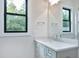 Bright bathroom features a gray vanity with quartz countertop at 92 Bluffside Ct, Pittsboro, NC 27312