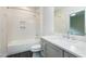 Modern bathroom featuring sleek gray vanity, marble countertop and elegant tile shower at 92 Bluffside Ct, Pittsboro, NC 27312