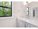 Bathroom boasts a gray vanity, quartz countertop, and large mirror at 92 Bluffside Ct, Pittsboro, NC 27312