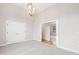 Large bedroom with designer light fixture and access to another room at 92 Bluffside Ct, Pittsboro, NC 27312