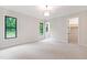 Spacious bedroom featuring large windows with scenic views, neutral color palette, and walk-in closet at 92 Bluffside Ct, Pittsboro, NC 27312