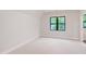 Cozy bedroom with neutral carpet, large window, and clean, minimalist design at 92 Bluffside Ct, Pittsboro, NC 27312