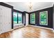 Well-lit bedroom featuring hardwood floors, modern lighting, and window seating, perfect for relaxation and enjoyment at 92 Bluffside Ct, Pittsboro, NC 27312