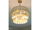 A stunning chandelier with three tiers of glass panels provides soft, ambient lighting at 92 Bluffside Ct, Pittsboro, NC 27312