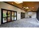 Spacious covered patio featuring ceiling fans, skylights, wood ceiling and stone fireplace at 92 Bluffside Ct, Pittsboro, NC 27312