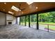 Spacious covered patio featuring ceiling fans, skylights, wood ceiling and stone fireplace at 92 Bluffside Ct, Pittsboro, NC 27312