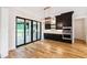Well-lit dining area with black cabinets, stainless appliances, and access to outdoor space at 92 Bluffside Ct, Pittsboro, NC 27312