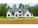 Stunning two-story home featuring a modern exterior with black trim and a well-maintained lawn at 92 Bluffside Ct, Pittsboro, NC 27312